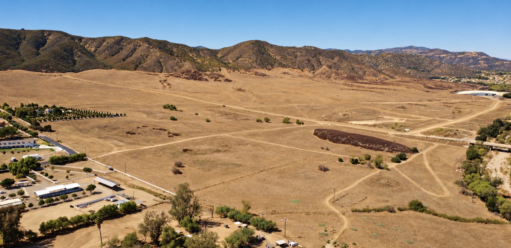 Aerial view of open riding trails and hills behind Silver Star Ranch